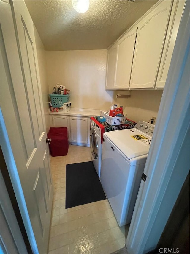 4041 Bluff Pl Unit 2, San Pedro, CA 90731 - laundry room featuring cabinet space, washer and dryer, and a textured ceiling