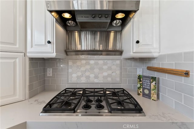 214 Sapphire Ave, Newport Beach, CA 92662 - kitchen with exhaust hood, white cabinets, backsplash, and stainless steel gas stovetop