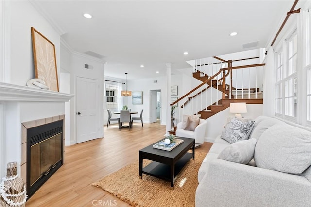 214 Sapphire Ave, Newport Beach, CA 92662 - living room with stairs, light wood-type flooring, a tile fireplace, recessed lighting, and baseboards