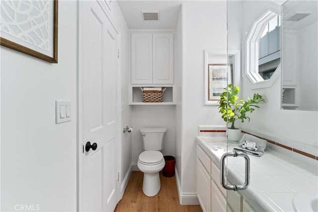 214 Sapphire Ave, Newport Beach, CA 92662 - bathroom featuring wood finished floors, double vanity, toilet, and baseboards