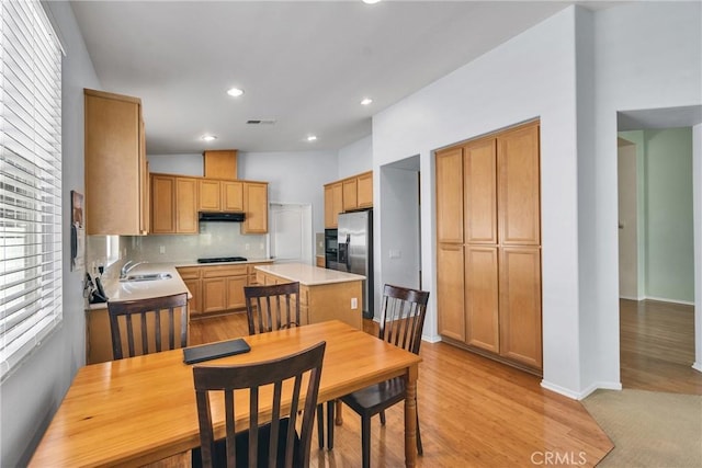 197 Potter Crk, Beaumont, CA 92223 - kitchen with stainless steel fridge with ice dispenser, light countertops, backsplash, a kitchen island, and a sink