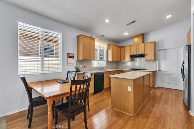 197 Potter Crk, Beaumont, CA 92223 - kitchen with black appliances, under cabinet range hood, light countertops, decorative backsplash, and a center island