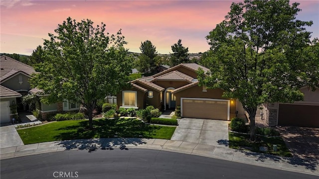 197 Potter Crk, Beaumont, CA 92223 - view of front facade featuring a tile roof, an attached garage, concrete driveway, stucco siding, and a front lawn