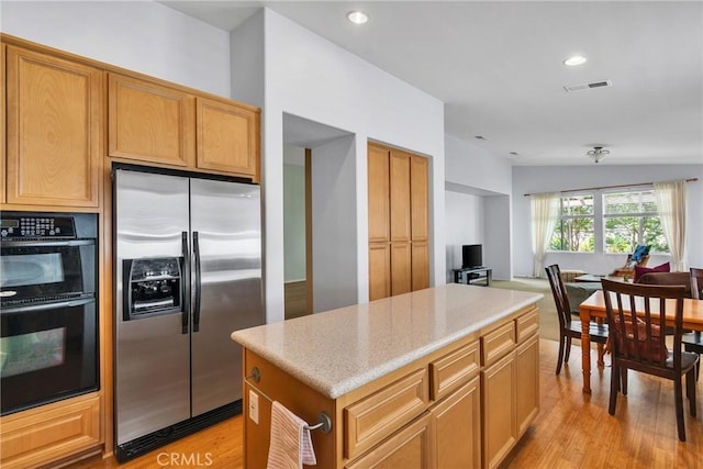 197 Potter Crk, Beaumont, CA 92223 - kitchen featuring stainless steel refrigerator with ice dispenser, a kitchen island, light wood-style flooring, light stone countertops, and recessed lighting