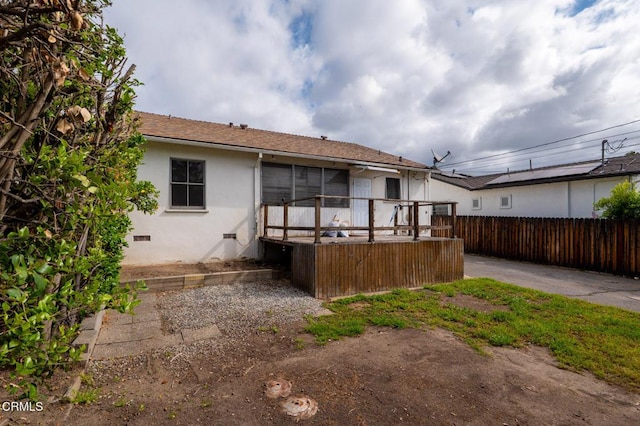 8528 Palma Vista St, San Gabriel, CA 91775 - rear view of property with fence, stucco siding, a wooden deck, and crawl space