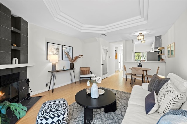 2500 Abbot Kinney Blvd Unit 9, Venice, CA 90291 - living room featuring a tray ceiling, wood finished floors, and a tile fireplace