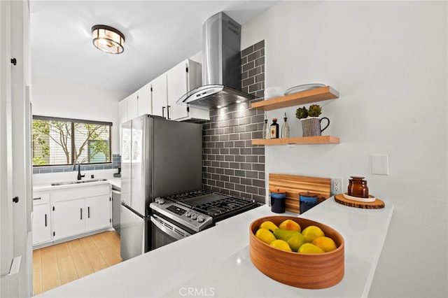 2500 Abbot Kinney Blvd Unit 9, Venice, CA 90291 - kitchen featuring wall chimney exhaust hood, stainless steel gas range oven, tasteful backsplash, a sink, and white cabinets