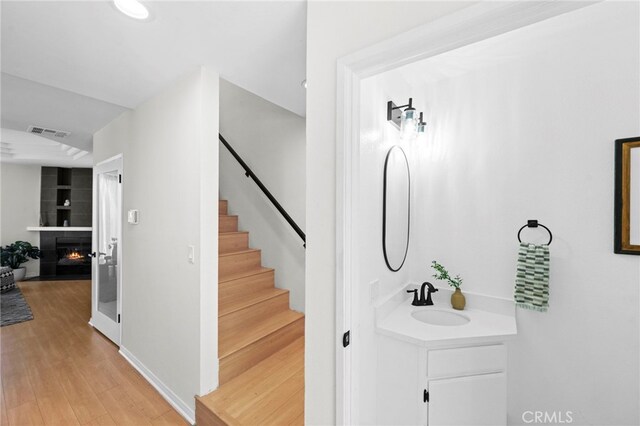 2500 Abbot Kinney Blvd Unit 9, Venice, CA 90291 - bathroom with wood finished floors, a lit fireplace, and vanity