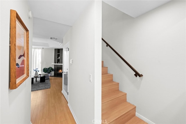 2500 Abbot Kinney Blvd Unit 9, Venice, CA 90291 - stairway with wood finished floors, a warm lit fireplace, and baseboards