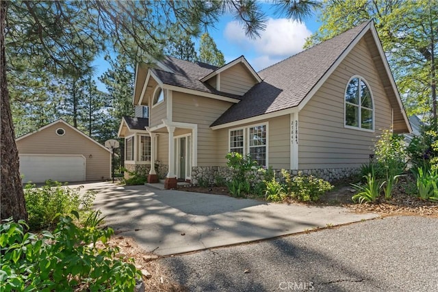 27847 St Bernard Ln, Lake Arrowhead, CA 92352 - view of front of home featuring an outdoor structure, a garage, roof with shingles, and stone siding