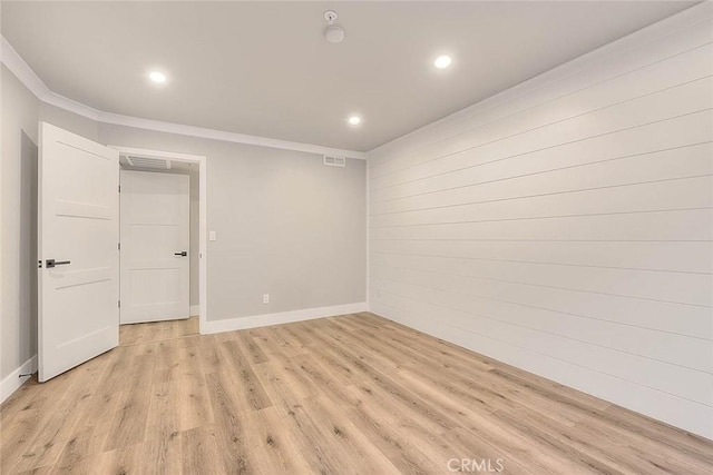 2040 Las Colinas Cir Unit 104, Corona, CA 92879 - unfurnished room with recessed lighting, light wood-style flooring, crown molding, baseboards, and wood walls