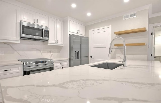2040 Las Colinas Cir Unit 104, Corona, CA 92879 - kitchen with appliances with stainless steel finishes, open shelves, recessed lighting, white cabinetry, and decorative backsplash