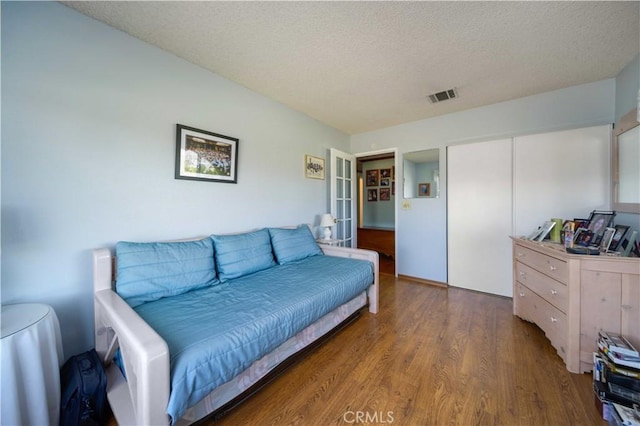 living area featuring wood finished floors and a textured ceiling
