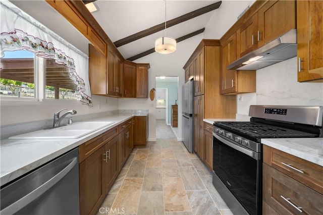 kitchen featuring under cabinet range hood, appliances with stainless steel finishes, a sink, brown cabinetry, and light stone finish floors