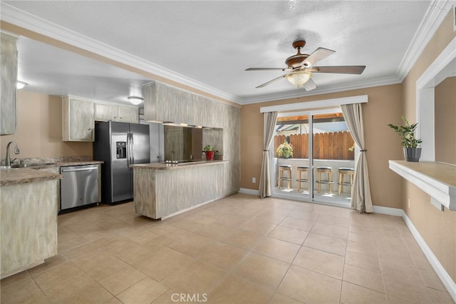 8631 Holly St, Rancho Cucamonga, CA 91701 - kitchen featuring stainless steel appliances, a sink, a peninsula, ornamental molding, and a ceiling fan