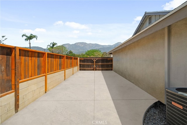 8631 Holly St, Rancho Cucamonga, CA 91701 - view of patio featuring central AC unit and a mountain view