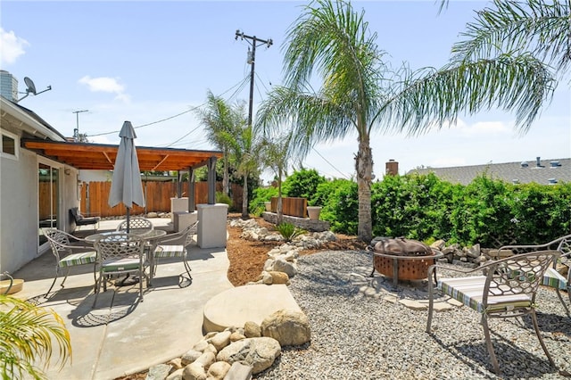 8631 Holly St, Rancho Cucamonga, CA 91701 - fenced backyard featuring an outdoor fire pit, a patio area, and outdoor dining space