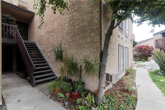 7890 E Spring St Unit 18D, Long Beach, CA 90815 - view of home's exterior featuring stucco siding and stairway