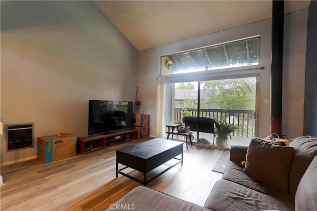 7890 E Spring St Unit 18D, Long Beach, CA 90815 - living room with high vaulted ceiling, wood finished floors, and heating unit