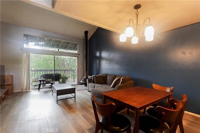 7890 E Spring St Unit 18D, Long Beach, CA 90815 - dining room featuring wood finished floors, a chandelier, baseboards, and lofted ceiling