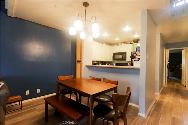 7890 E Spring St Unit 18D, Long Beach, CA 90815 - dining space featuring wood finished floors, baseboards, and recessed lighting