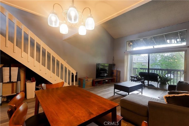 7890 E Spring St Unit 18D, Long Beach, CA 90815 - living area featuring stairs, wood finished floors, a chandelier, and high vaulted ceiling