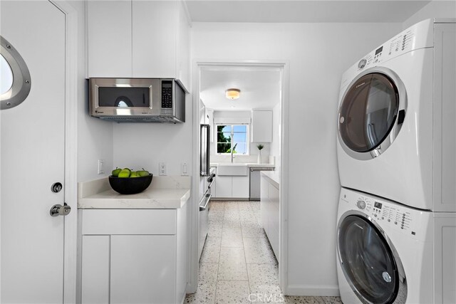 2142 Ruby Pl, Laguna Beach, CA 92651 - laundry room with stacked washer / dryer and cabinet space