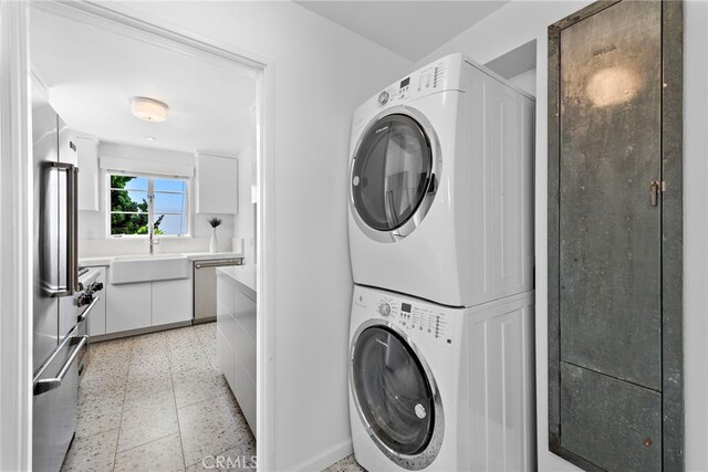 2142 Ruby Pl, Laguna Beach, CA 92651 - clothes washing area featuring stacked washer and clothes dryer and baseboards