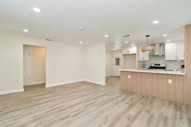 1988 Thornton St, Riverside, CA 92507 - kitchen featuring wall chimney range hood, stainless steel range oven, recessed lighting, light wood-style floors, and light countertops