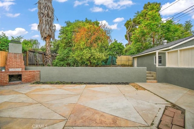 1988 Thornton St, Riverside, CA 92507 - view of patio / terrace with fence and an outdoor brick fireplace