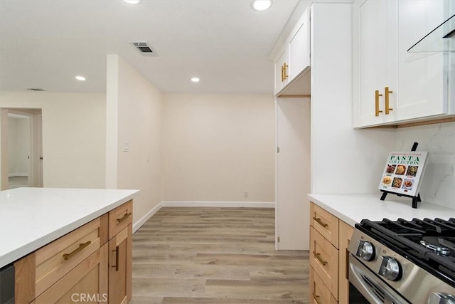 1988 Thornton St, Riverside, CA 92507 - kitchen with light wood-style flooring, recessed lighting, white cabinetry, stainless steel gas stove, and baseboards