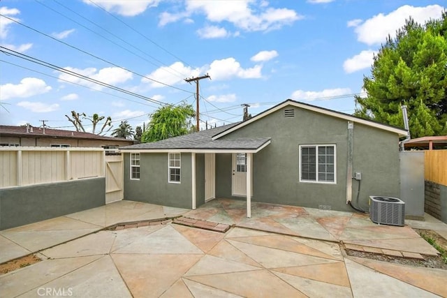 1988 Thornton St, Riverside, CA 92507 - rear view of house with stucco siding, fence, cooling unit, and a patio