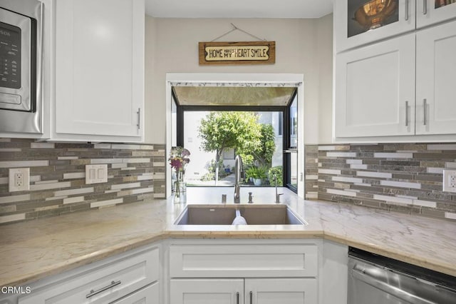 825 Murdoch Ln, Ventura, CA 93003 - kitchen with stainless steel appliances, a sink, white cabinetry, and backsplash