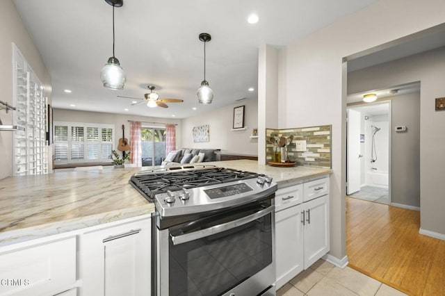 825 Murdoch Ln, Ventura, CA 93003 - kitchen featuring gas stove, a ceiling fan, white cabinetry, light stone countertops, and open floor plan