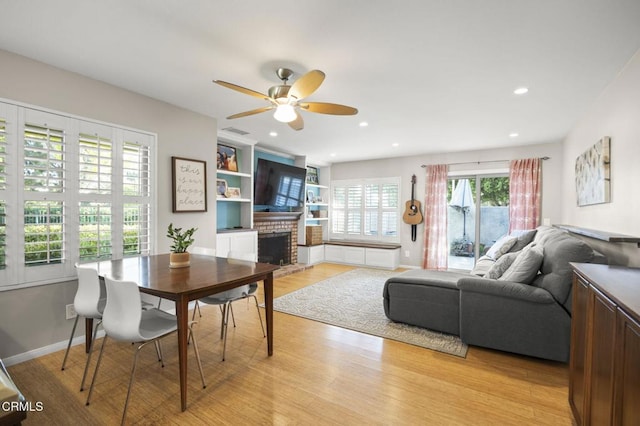 825 Murdoch Ln, Ventura, CA 93003 - dining area featuring ceiling fan, a fireplace, light wood-style floors, recessed lighting, and baseboards