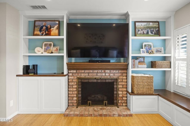825 Murdoch Ln, Ventura, CA 93003 - living room with light wood-style floors, a brick fireplace, built in features, and ornamental molding