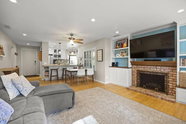 825 Murdoch Ln, Ventura, CA 93003 - living room with light wood finished floors, a ceiling fan, recessed lighting, a fireplace, and baseboards