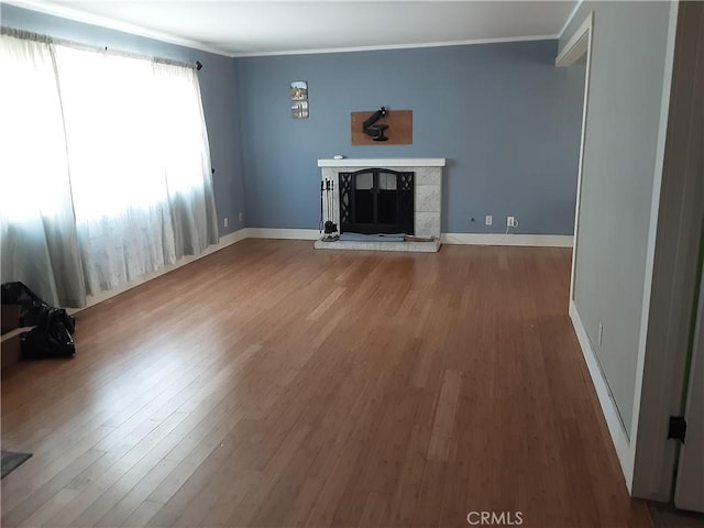 6473 Capistrano Way, Riverside, CA 92504 - unfurnished living room with wood finished floors, ornamental molding, a tile fireplace, and baseboards