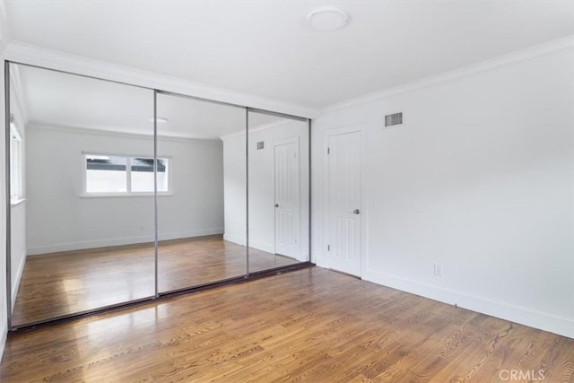 12535 Kling St, Studio City, CA 91604 - unfurnished bedroom featuring ornamental molding, baseboards, and wood finished floors