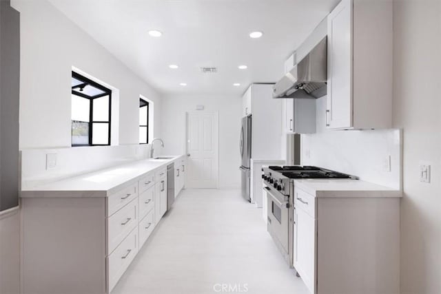 12535 Kling St, Studio City, CA 91604 - kitchen featuring exhaust hood, appliances with stainless steel finishes, white cabinets, a sink, and recessed lighting