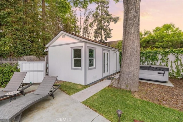 12535 Kling St, Studio City, CA 91604 - outdoor structure at dusk with a hot tub, fence, and an outdoor structure