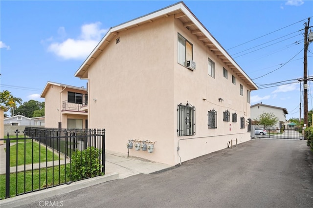 3065 Sastre Ave, El Monte, CA 91733 - view of home's exterior with stucco siding, a balcony, a gate, and cooling unit