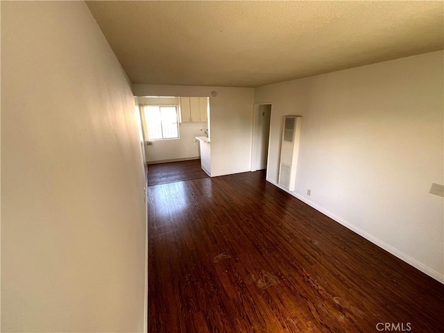 3065 Sastre Ave, El Monte, CA 91733 - spare room featuring baseboards, a heating unit, and dark wood-type flooring