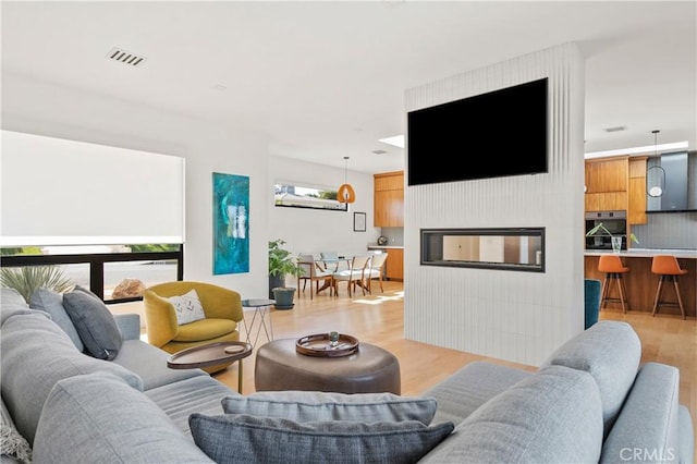 4756 Keniston Ave, View Park, CA 90043 - living room with light wood-style floors and a fireplace