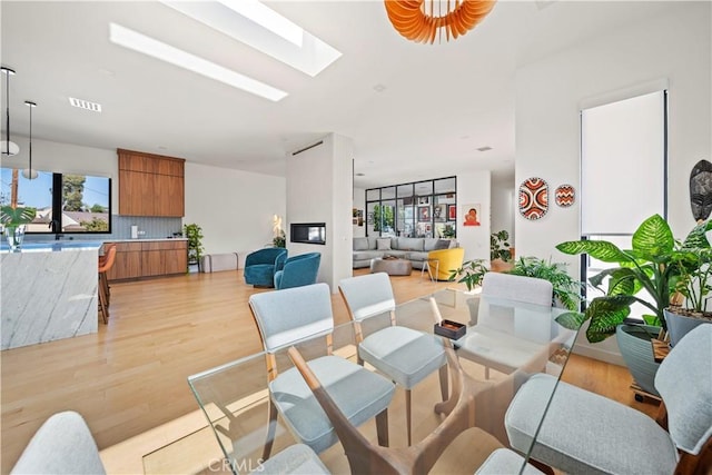 4756 Keniston Ave, View Park, CA 90043 - dining space with light wood-style floors and a skylight