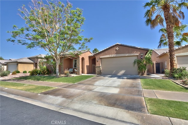 84692 Pavone Way, Indio, CA 92203 - view of front of house featuring stucco siding, an attached garage, stone siding, driveway, and a front yard
