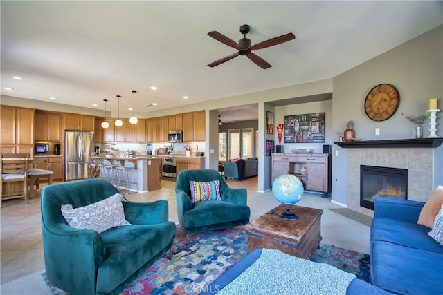 84692 Pavone Way, Indio, CA 92203 - living room with ceiling fan, recessed lighting, a fireplace, and light tile patterned floors