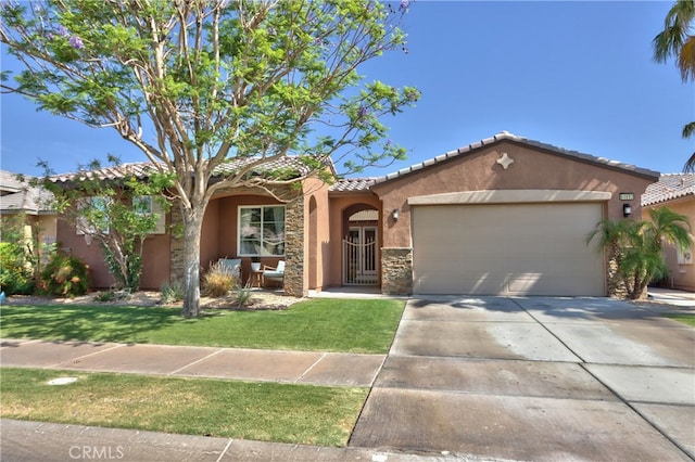 84692 Pavone Way, Indio, CA 92203 - mediterranean / spanish-style house with stone siding, stucco siding, a tile roof, a garage, and concrete driveway