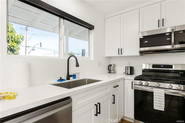 10290 Monte Vista Ave, Montclair, CA 91763 - kitchen with appliances with stainless steel finishes, a sink, white cabinetry, and light countertops