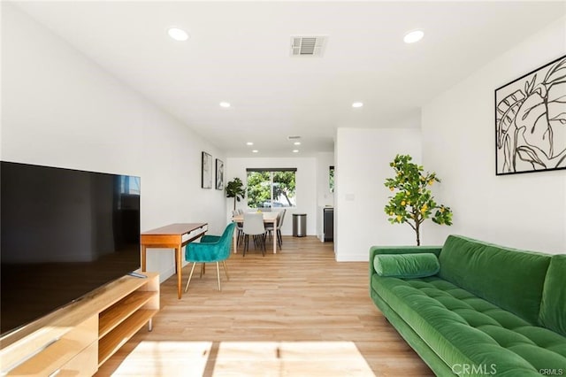 10290 Monte Vista Ave, Montclair, CA 91763 - living room with light wood finished floors, recessed lighting, and baseboards